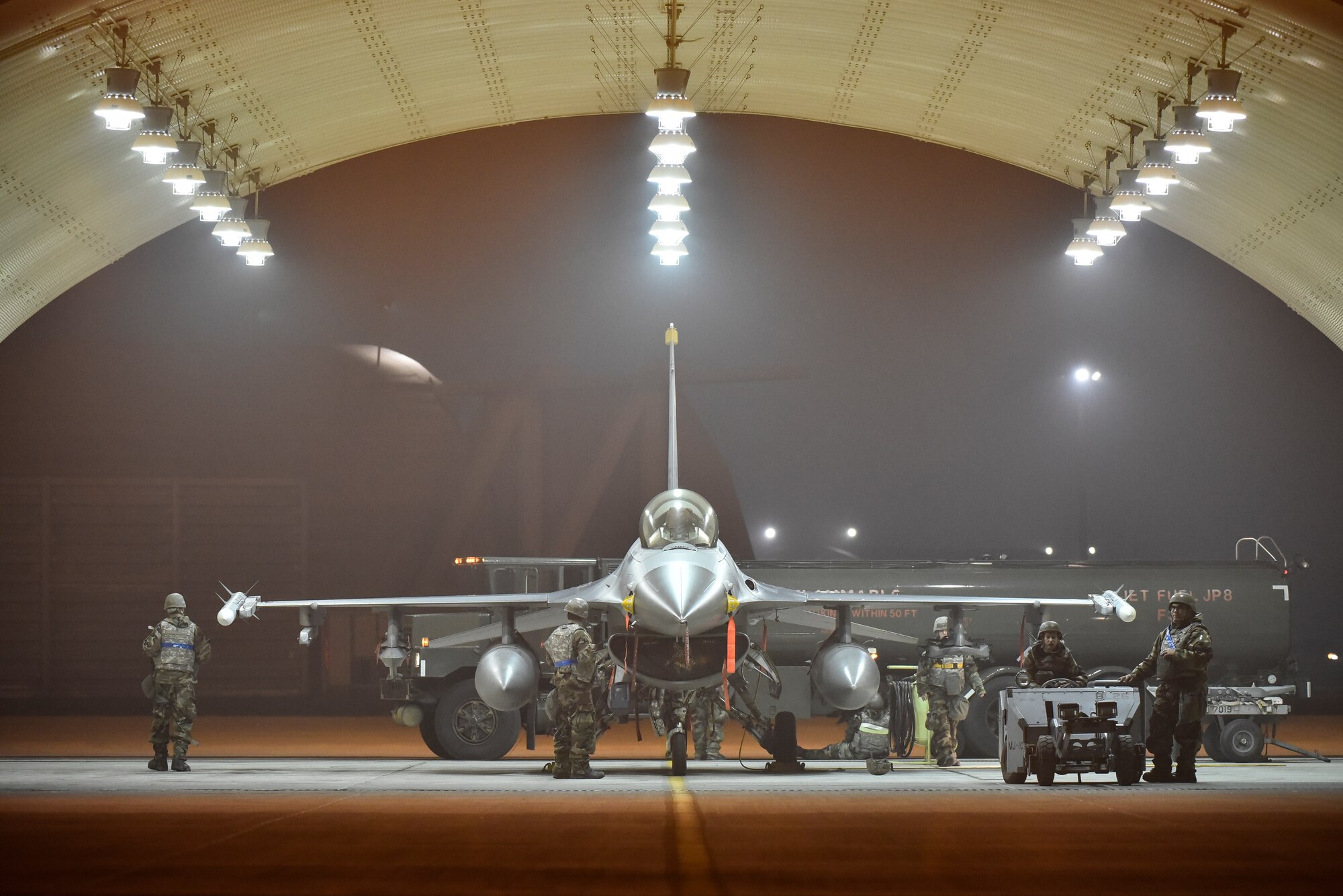 Airmen prepping a fighter jet for flight.