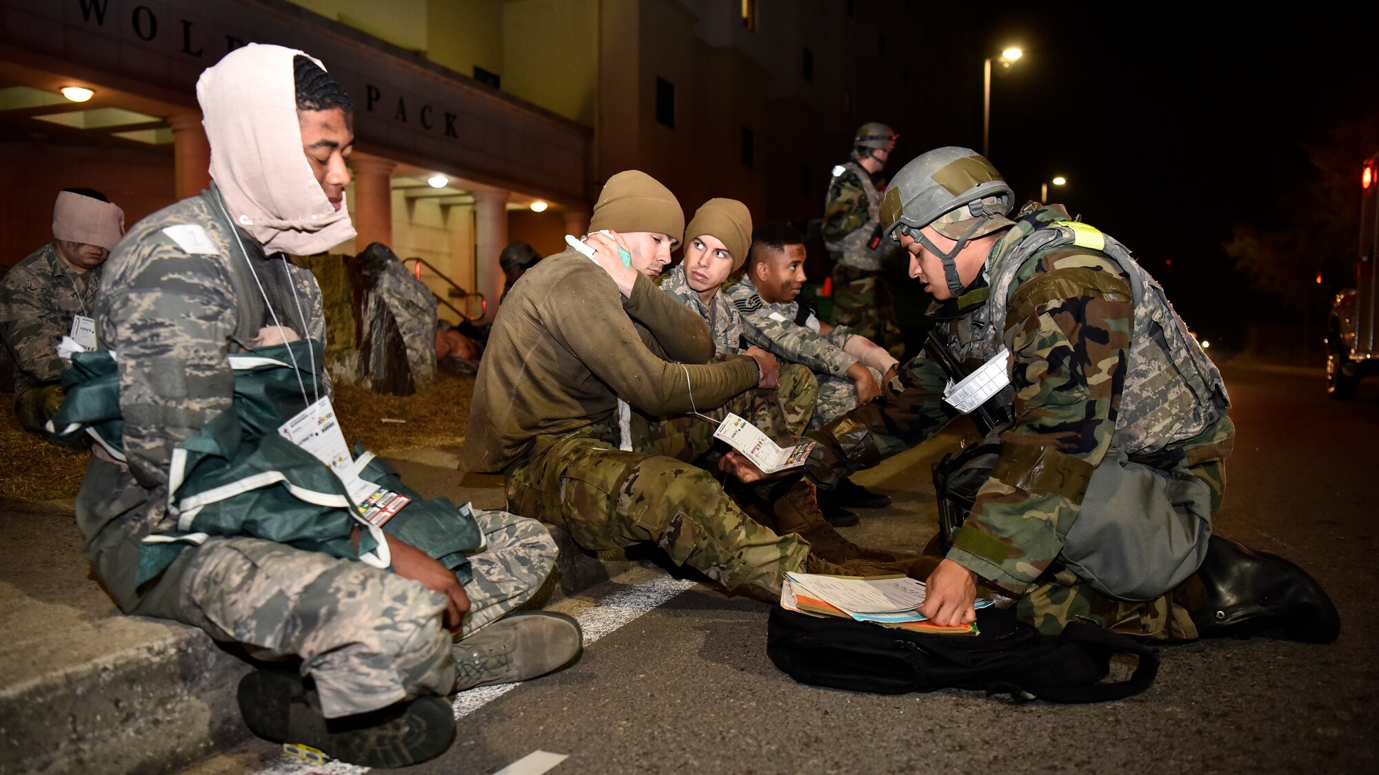 An Airman assessing simulated victims.
