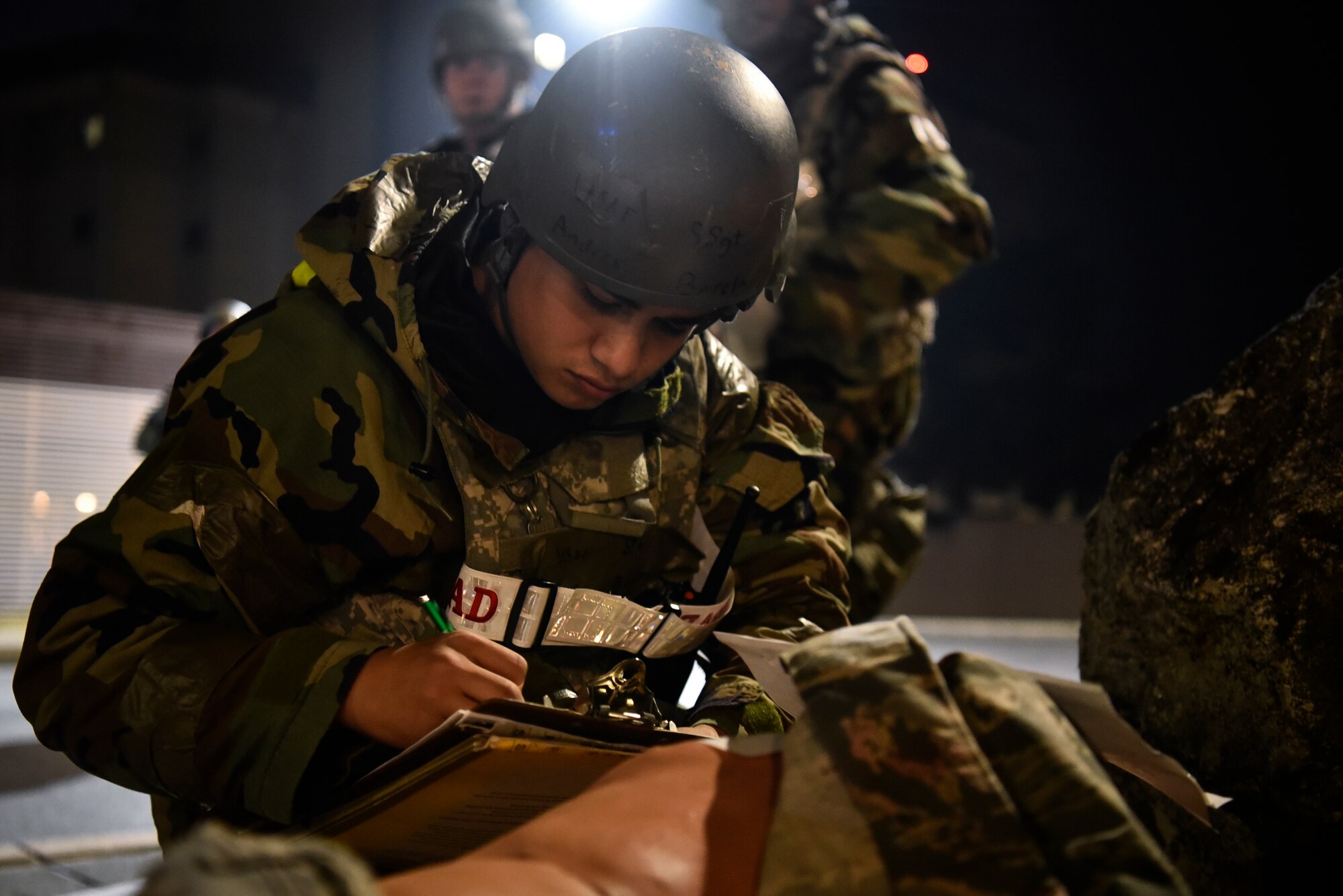 An Airmen assess a simulated victim during a training event.