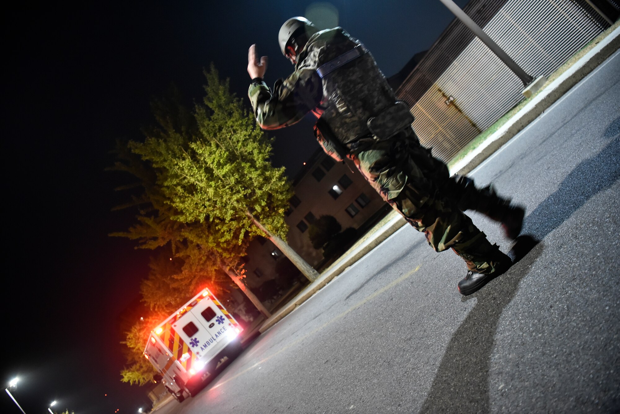 An Airman assists an ambulance leaving a training event.