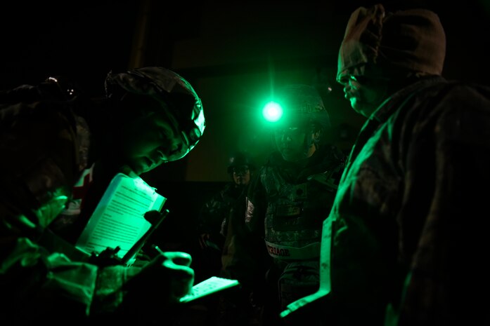 Medical Airmen process a simulated victim for medical treatment.