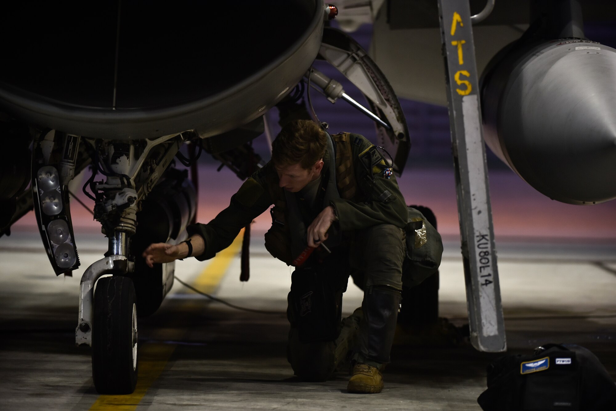 A pilot inspecting an aircraft before flight.