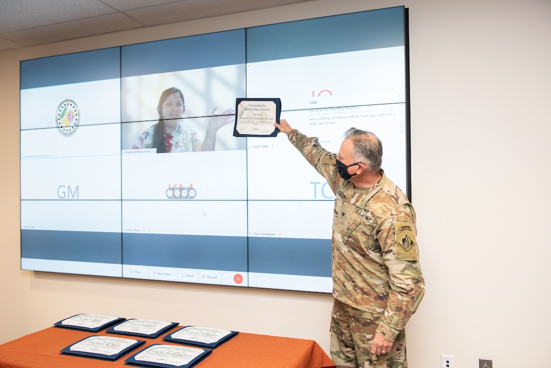 TAM Commander COL Philip Secrist presents a certificate to architect Angelivette Nieves-Viruet who completed the Leadership Development Program Tier I and graduated virtually from Puerto Rico.