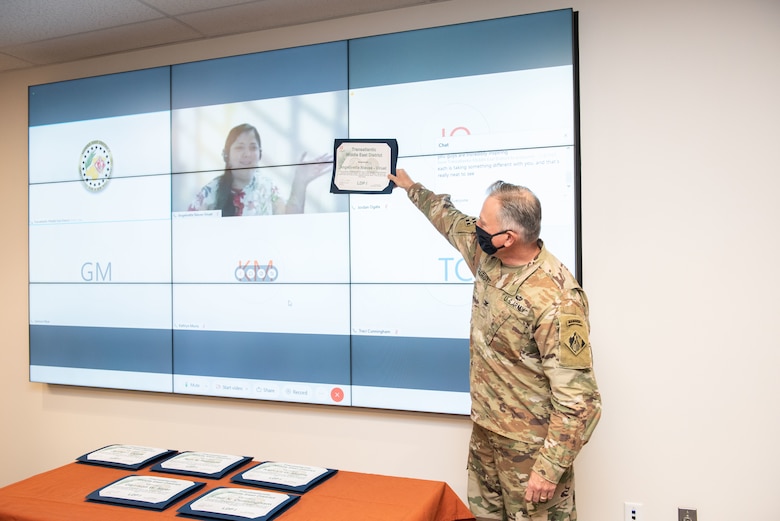 TAM Commander COL Philip Secrist presents a certificate to architect Angelivette Nieves-Viruet who completed the Leadership Development Program Tier I and graduated virtually from Puerto Rico.