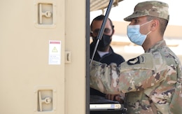 Soldiers from the 58th Signal Company, 101st Division Sustainment Brigade, 101st Airborne Division (Air Assault), and the 304th Sustainment Brigade, 1st Theater Sustainment Command, collaborate during a validation exercise October 24, 2020, on Camp Arifjan, Kuwait, to ensure theater specific configurations are installed and programed on the brigade's communications equipment.