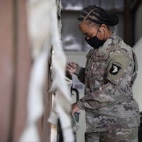 Sgt. Quayshaun Hopkins, a native of Hopkinsville, Ky., who is an automated logistical specialist assigned to 227th Composite Supply Company, 101st Division Sustainment Brigade, 101st Airborne Division (Air Assault), secures and package supplies on Camp Arifjan, Kuwait, October 23, 2020