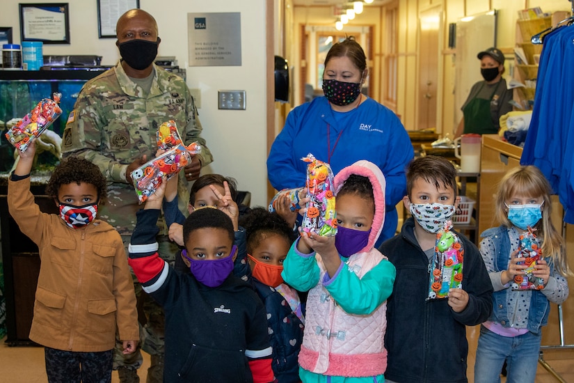Command Sgt. Maj. Kenneth F. Law, U.S. Army Financial Management Command senior enlisted advisor, poses with several students at a childcare center located next to the Maj. Gen. Emmett J. Bean Federal Center Oct. 26, 2020. Law delivered more than 80 treat bags filled with candy and toys donated from USAFMCOM employees to give to the students, who typically parade through the Bean Center around Halloween each year. (U.S. Army photo by Mark R. W. Orders-Woempner)