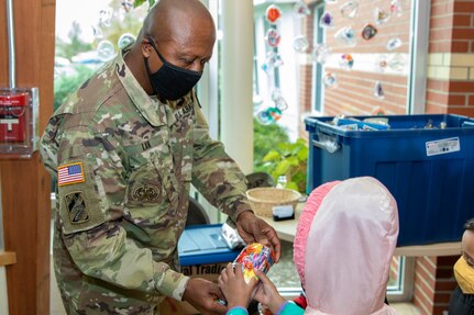 Command Sgt. Maj. Kenneth F. Law, U.S. Army Financial Management Command senior enlisted advisor, hands out a treat bag to a student at a childcare center located next to the Maj. Gen. Emmett J. Bean Federal Center Oct. 26, 2020. Law delivered more than 80 treat bags filled with candy and toys donated from USAFMCOM employees to give to the students, who typically parade through the Bean Center around Halloween each year. (U.S. Army photo by Mark R. W. Orders-Woempner)