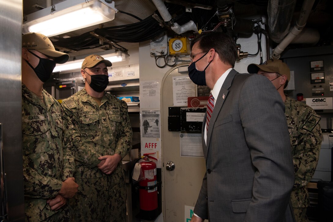 Defense Secretary Dr. Mark T. Esper talks with service members.