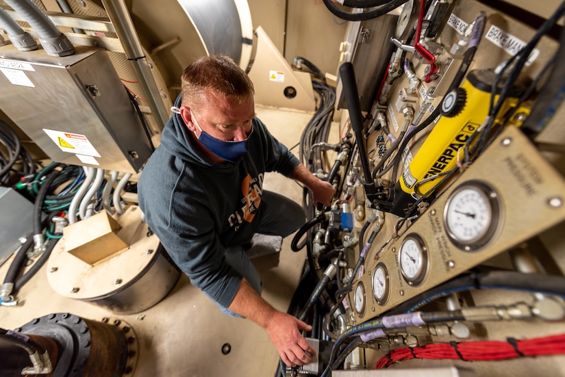 Photo of Electronics mechanic Jamie Shotto conducting a test inside the PSS-T trailer.