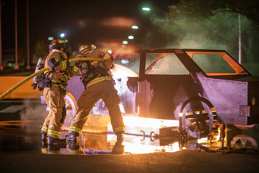 Firefighters extinguish flames from a fire simulator during Exercise Active Shield aboard MCAS Iwakuni, Japan, Oct. 29.
