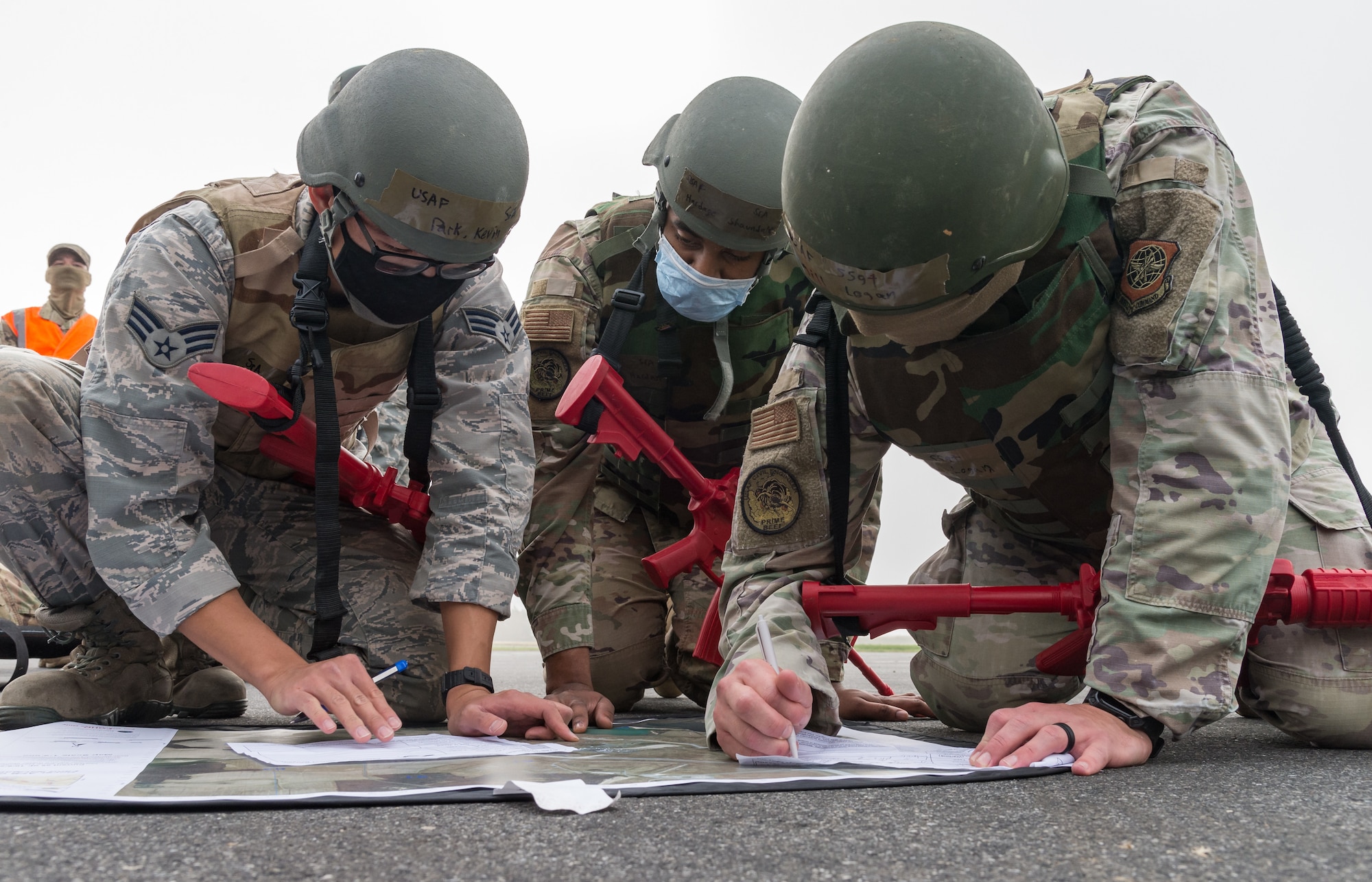 Prime Base Engineer Emergency Force members from the 436th Civil Engineer Squadron use a map to plot waypoints during a landing navigation exercise Oct. 21, 2020, on Dover Air Force Base, Delaware. Sixty-four Prime BEEF members made up 10 teams in a 96-hour readiness exercise that included self-aid and buddy care, vehicle convoy techniques and land navigation exercises prior to arriving at the Tactics and Leadership Nexus. While at the TALN, they participated in night vision goggle familiarization; chemical, biological and radiological and nuclear defense training; individual movement techniques; and defense fighting position exercises. (U.S. Air Force photo by Roland Balik)