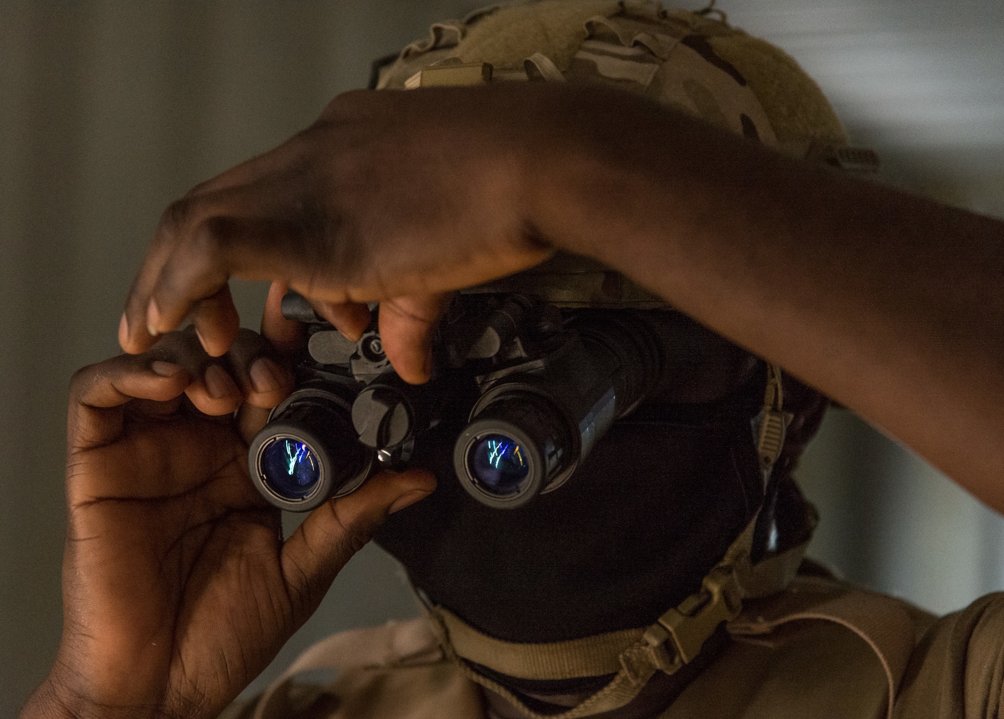 A 436th Civil Engineer Squadron Prime Base Engineer Emergency Force member adjusts his night vision goggles prior to the start of a night vision goggle obstacle course exercise Oct. 21, 2020, at Tactics and Leadership Nexus on Dover Air Force Base, Delaware. Sixty-four Prime BEEF members made up 10 teams participated in a 96-hour readiness exercise that included self-aid and buddy care, vehicle convoy techniques and land navigation prior to arriving at the TALN. While at TALN, they participated in night vision goggle familiarization; chemical, biological and radiological and nuclear defense training; individual movement techniques; and defense fighting position exercises. (U.S. Air Force photo by Roland Balik)