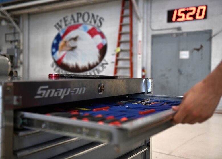 U.S. Air Force Airman 1st Class Micahel Foy, 33rd Aircraft Maintenance Squadron weapons load crew member, inspects tools before a weapons load competition Oct. 6, 2020, at Eglin Air Force Base, Florida. The competition showed 3-man crews displaying their skills in a timed and graded contest while being evaluated on safety and how closely they follow joint technical data. (U.S. Air Force photo by Senior Airman Amber Litteral)