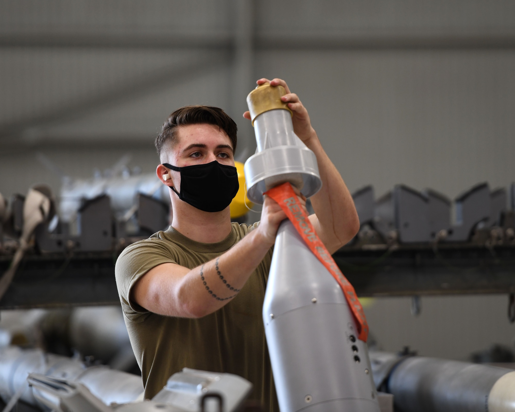 Airman 1st Class Michael Foy, 33rd Aircraft Maintenance Squadron weapons load crew member, preps an unarmed GBU-12 Pave way bomb during a weapons load competition Oct. 6, 2020, at Eglin Air Force Base, Florida. The competition showed 3-man crews displaying their skills in a timed and graded contest while being evaluated on safety and how closely they follow joint technical data. (U.S. Air Force photo by Senior Airman Amber Litteral)