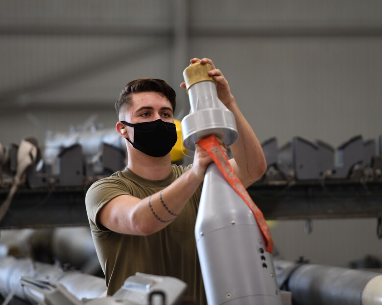 Airman 1st Class Michael Foy, 33rd Aircraft Maintenance Squadron weapons load crew member, preps an unarmed GBU-12 Pave way bomb during a weapons load competition Oct. 6, 2020, at Eglin Air Force Base, Florida. The competition showed 3-man crews displaying their skills in a timed and graded contest while being evaluated on safety and how closely they follow joint technical data. (U.S. Air Force photo by Senior Airman Amber Litteral)