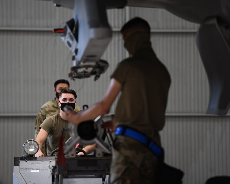 Airman 1st Class Michael Foy, a 33rd Aircraft Maintenance Squadron weapons load crew member, operates a bomb lift during a weapons load competition Oct. 6, 2020, at Eglin Air Force Base, Florida.  A 3-man crew loaded unarmed GBU-12 Pave Way and GBU-31 V1 bombs onto an F-35 in a timed contest that graded their skills, safety and accuracy following joint technical data. (U.S. Air Force photo by Senior Airman Amber Litteral)