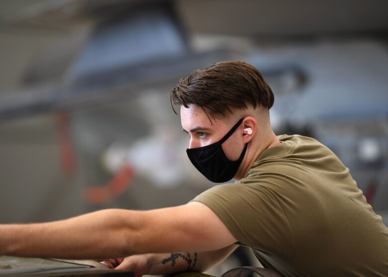 Airman 1st Class Michael Foy, a 33rd Aircraft Maintenance Squadron weapons load crew member, secures munitions cargo during a weapons load competition Oct. 6, 2020, at Eglin Air Force Base, Florida. Held quarterly, weapons load competitions give Airmen an opportunity to practice their technical skills in a controlled and graded environment. (U.S. Air Force photo by Senior Airman Amber Litteral)