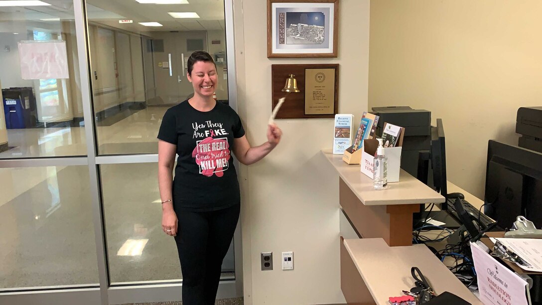 U.S. Air Force Maj. Jessica Brooks rings the bell that symbolizes the end of her radiation therapy at Walter Reed National Military Medical Center, Bethesda, Md., Aug. 1, 2019.