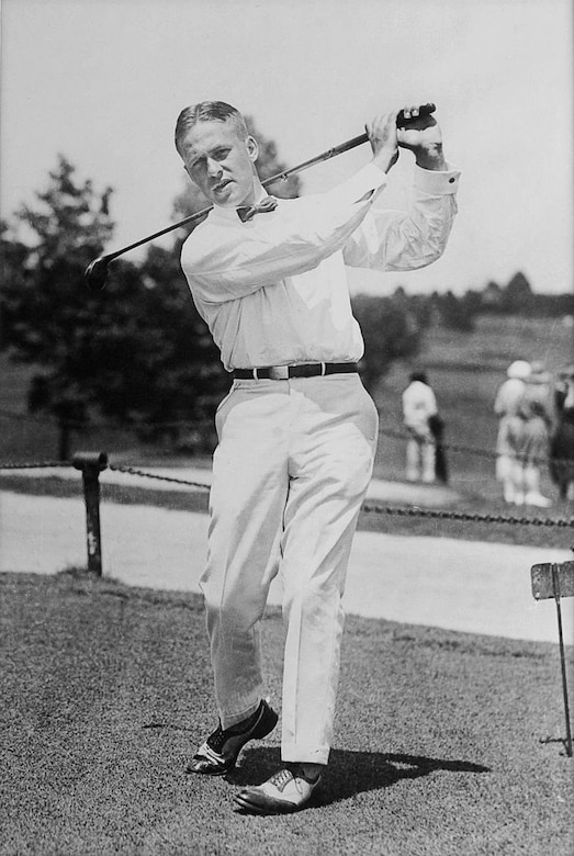 A man swings a golf club.