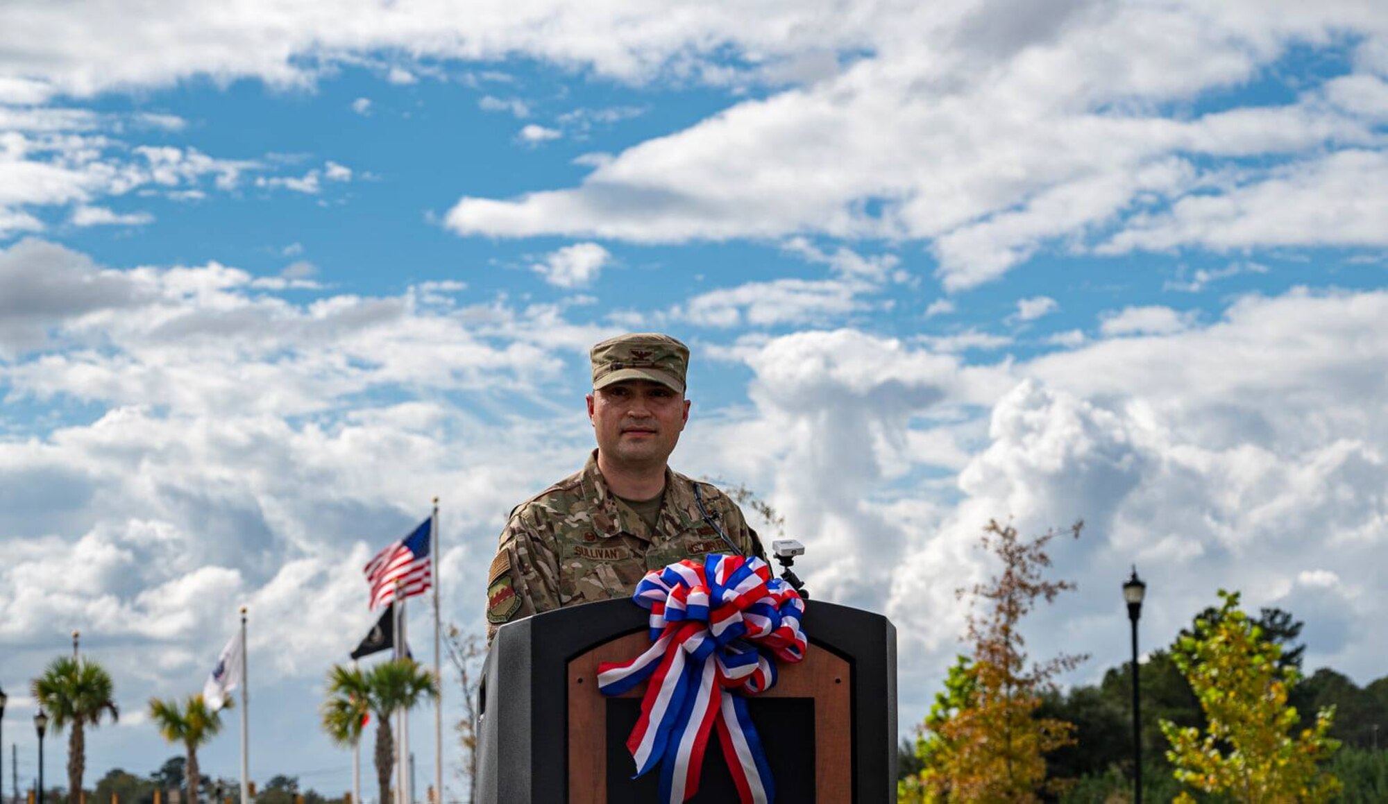 An Air Force member stands behind a podium.