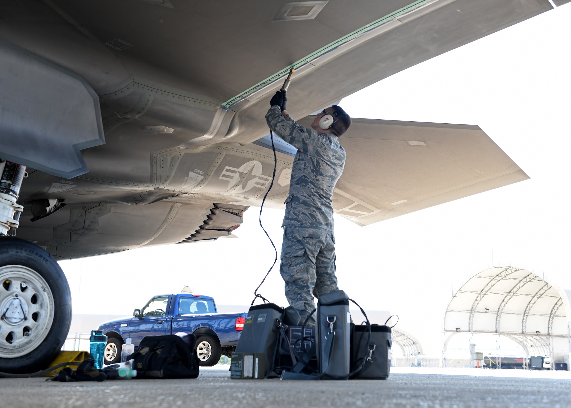 U.S Air Force Airman 1st Class Samuel Gleason, a 33rd Maintenance Fabrication Flight low observable aircraft structure maintenance apprentice, applies fastener filler onto the underside of wing Oct. 5, 2020 at Eglin Air Force Base, Florida. Maintenance jobs like this are completed on a weekly basis to restore LO capabilities. (U.S. Air Force photo by Senior Airman Amber Litteral)