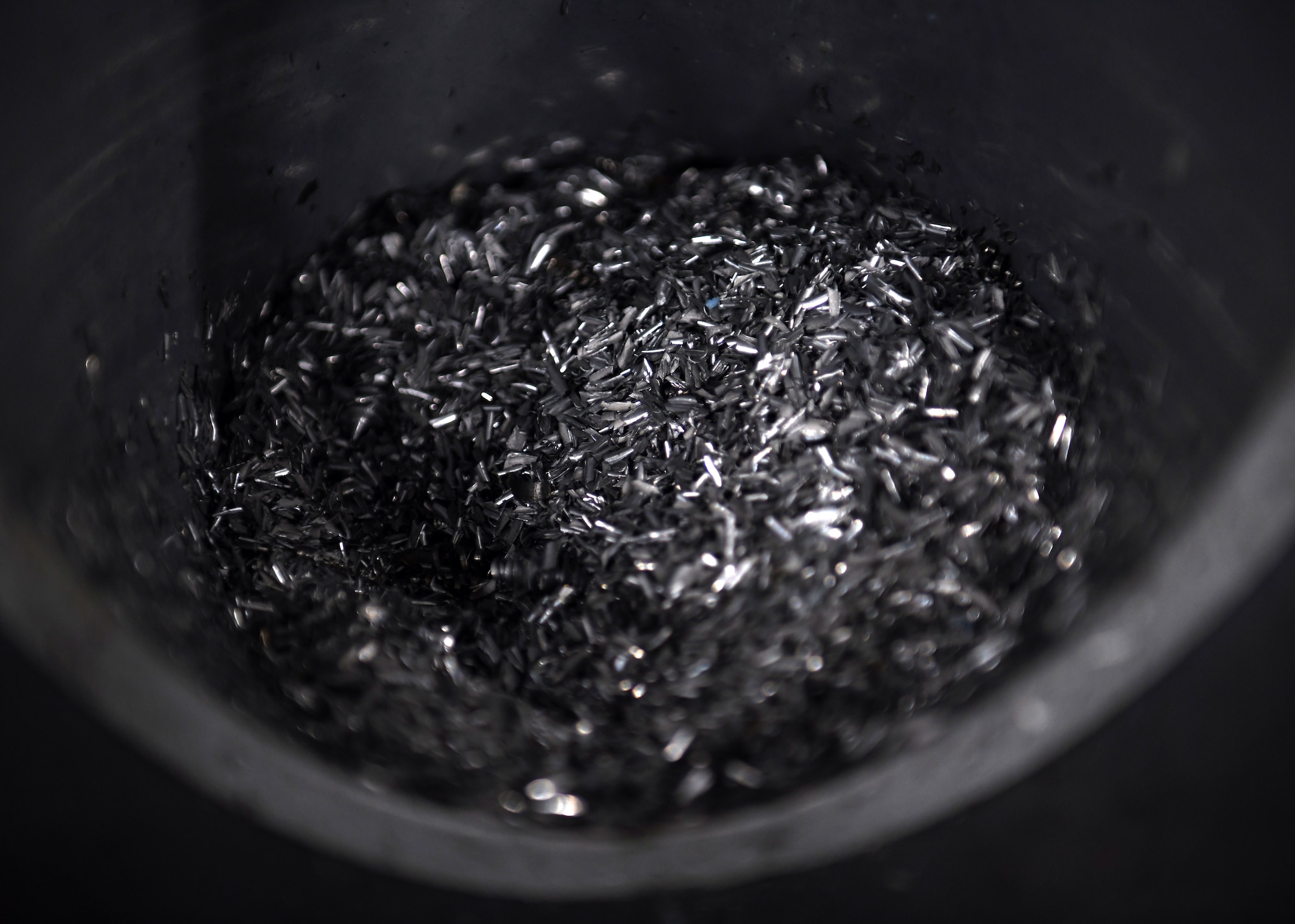 Metals chips leftover from past maintenance jobs sit in a collection bin Oct. 7, 2020, at Eglin Air Force Base, Florida. Metals flight Airmen create custom tools or equipment pieces to use for various maintenance jobs across the wing. (U.S. Air Force photo by Airman 1st Class Amber Litteral)