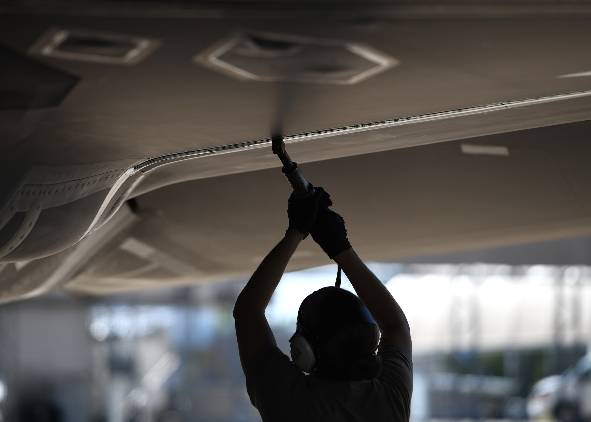 U.S. Air Force Senior Airman Kari Akins, a 33rd Maintenance Fabrication Flight low observable aircraft structure maintenance journeyman, applies fastener filler onto the underside of wing Oct. 5, 2020. Maintenance jobs like this are completed on a weekly basis to restore LO capabilities. (U.S. Air Force photo by Senior Airman Amber Litteral)