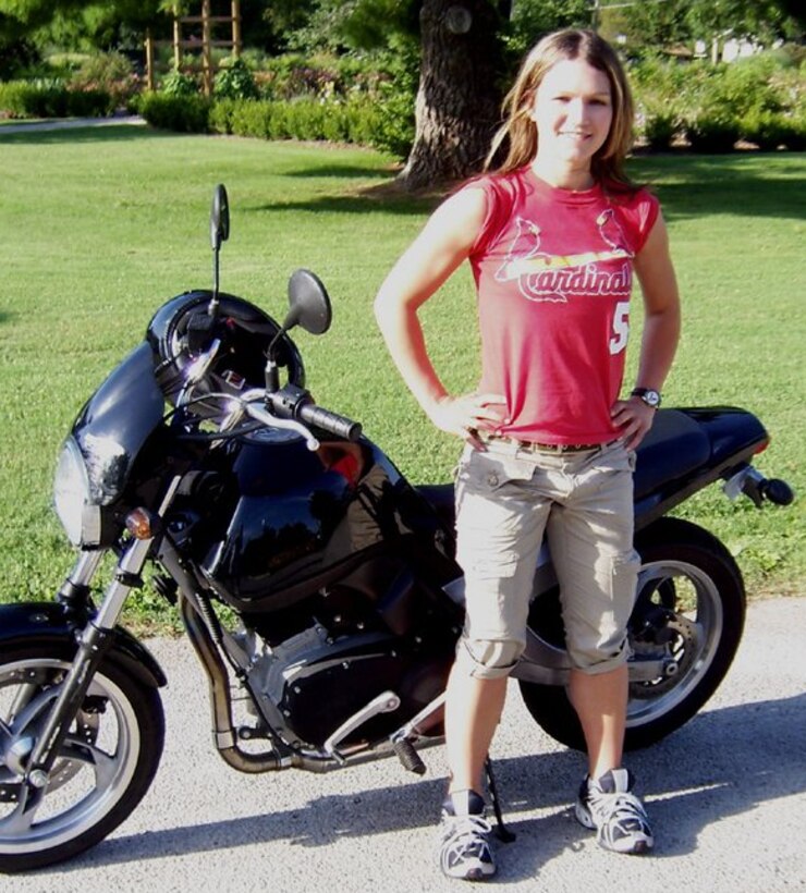 Courtesy photo of a Tech. Sgt. Nyssa Curtis, Air Force Reserve Chaplain Assistant, posing in front of her motorcycle.