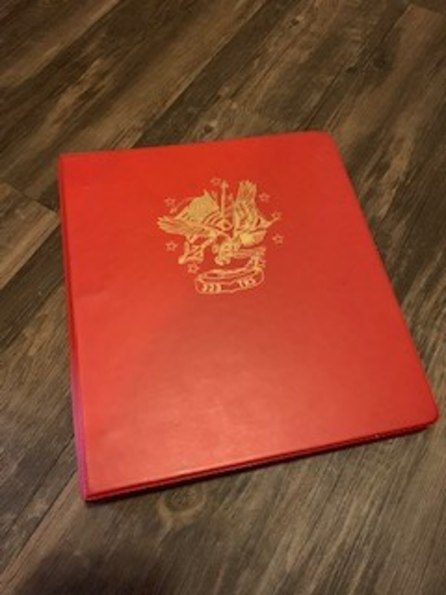 Courtesy photo of a red binder from basic training that kept personal letters from home for Tech. Sgt. Nyssa Curtis, Air Force Reserve Chaplain Assistant,