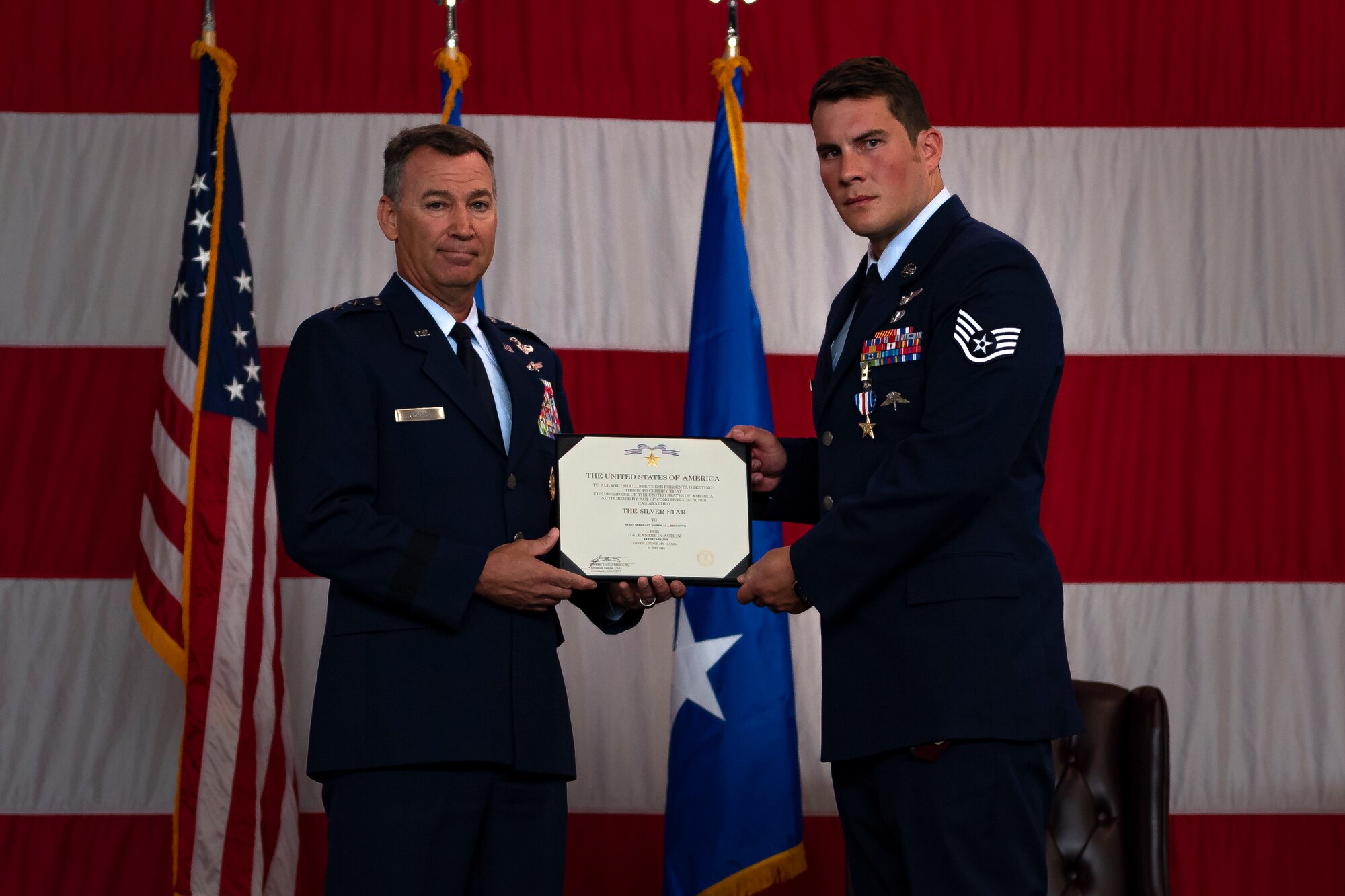 A photo of an Airman receiving a certificate