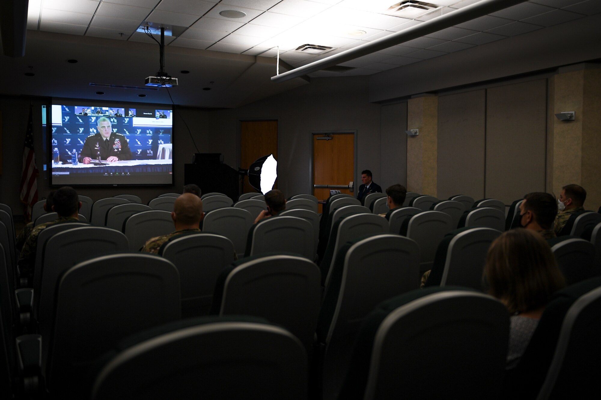 A photo of Airmen watching a virtual ceremony