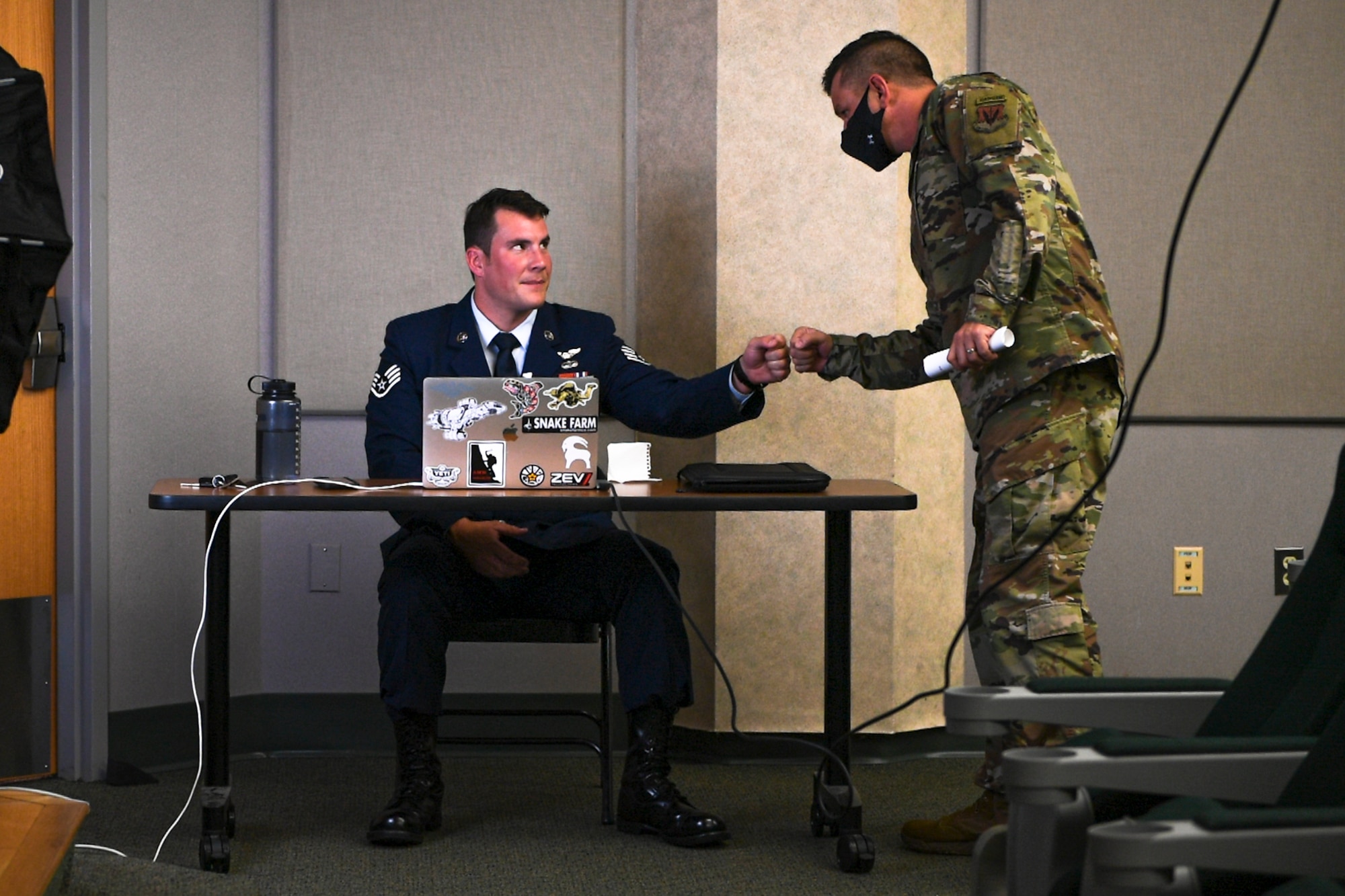 A photo of Airmen bumping fists