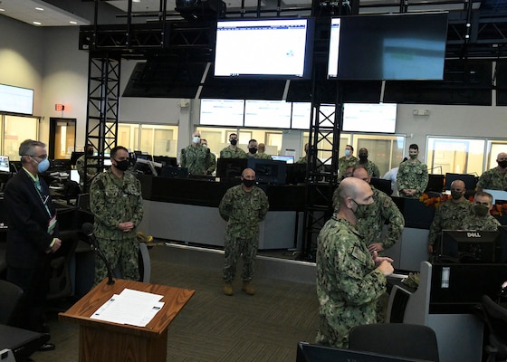 Chief of Naval Operations (CNO) Adm. Mike Gilday receives a command brief from Cdr. William Campbell while touring the Naval Network Warfare Command (NNWC) and Navy Cyber Defense Operations Command (NCDOC) watch floor. (U.S. Navy photo by Robert Fluegel)