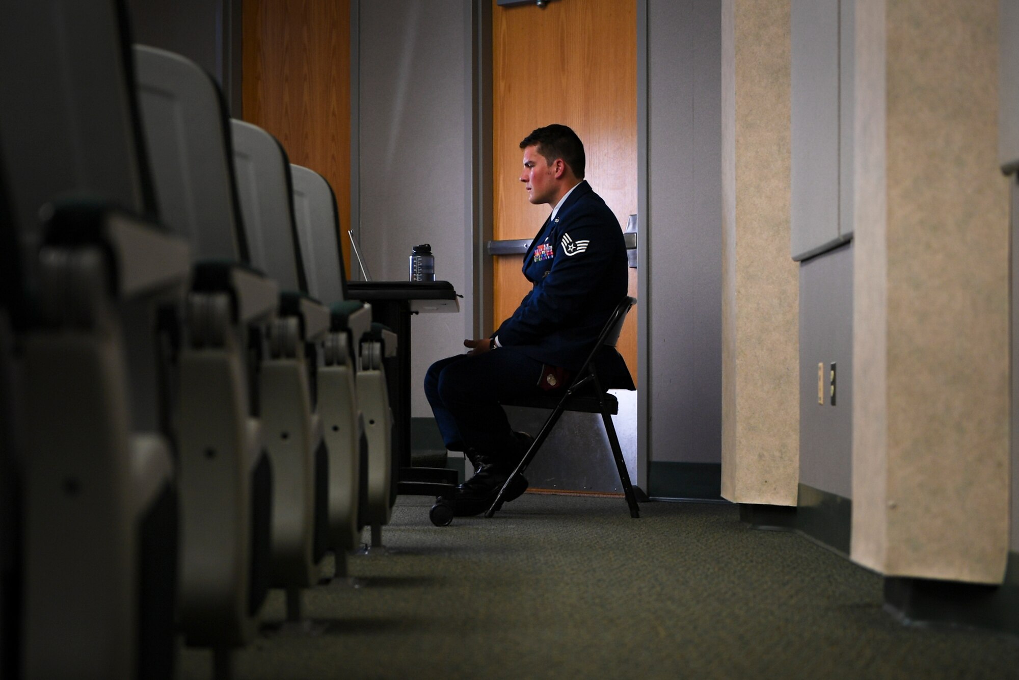 A photo of an Airman preparing to speak during a ceremony