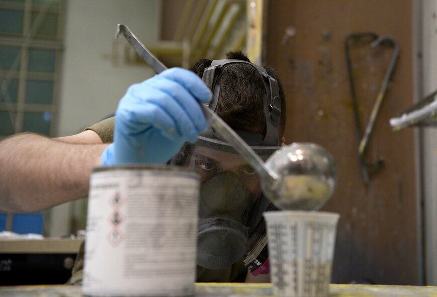 U.S. Air Force Airman Mason Henry, a 354th Maintenance Squadron Aircraft Structural Maintenance journeyman, mixes paint for an F-16 Fighting Falcon part on Eielson Air Force Base, Alaska, Oct. 8, 2020.