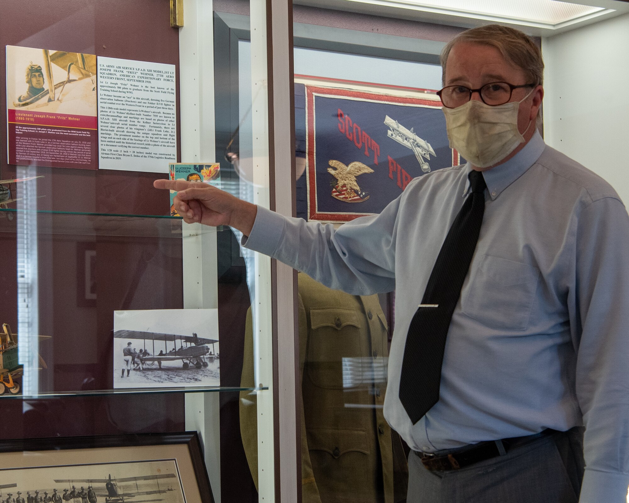 Man points at display case.