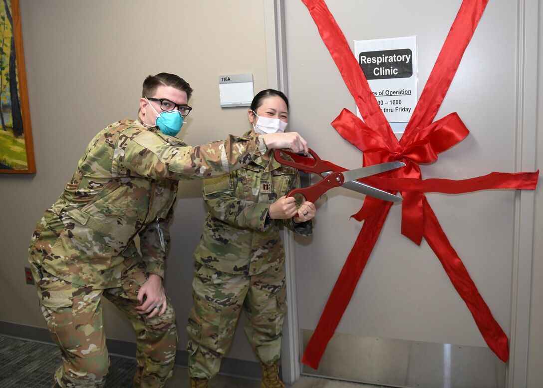 U.S. Air Force Staff Sgt. Parker Miller, 92nd Medical Group Respiratory Clinic flight medical assistant, and Capt. Melissa Cadorette, 92nd MDG Respiratory Clinic flight chief, perform a ribbon cutting as part of Team Fairchild’s new Respiratory Clinic opening at Fairchild Air Force Base, Washington, Oct. 26, 2020. With the opening of the new Respiratory Clinic, the 92nd MDG and Team Fairchild are able to ensure high quality care for all Airmen, Families and retirees, while enhancing both quality of life and service. (U.S. Air Force photo by Airman 1st Class Kiaundra Miller)