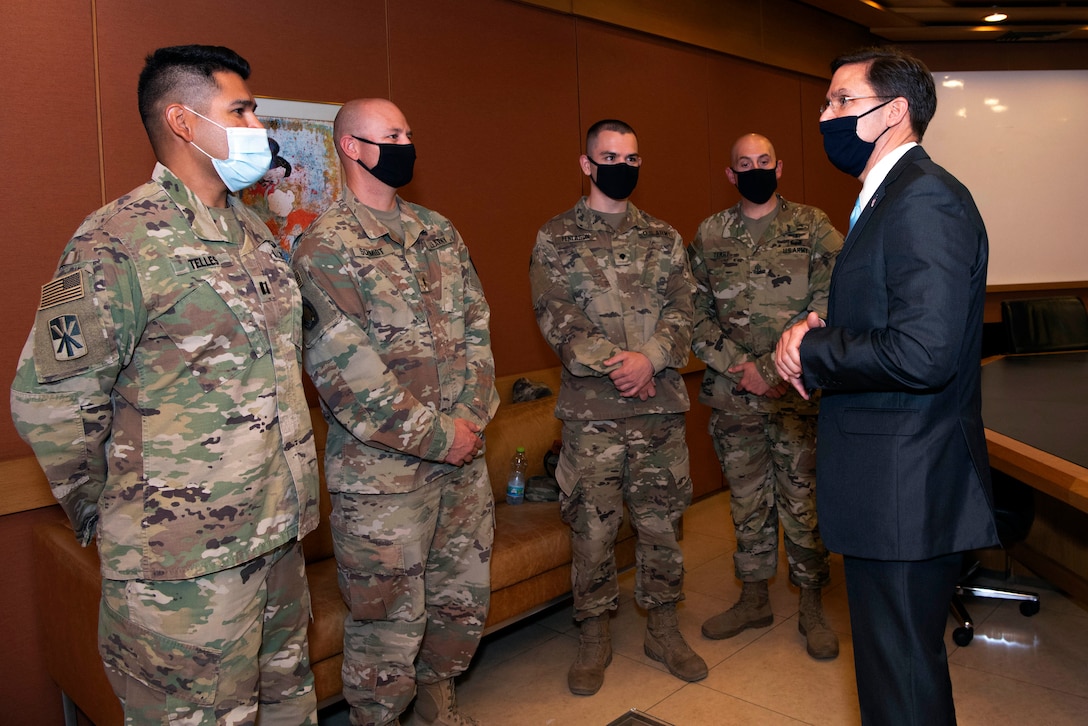 Defense Secretary Dr. Mark T. Esper talks with four soldiers.
