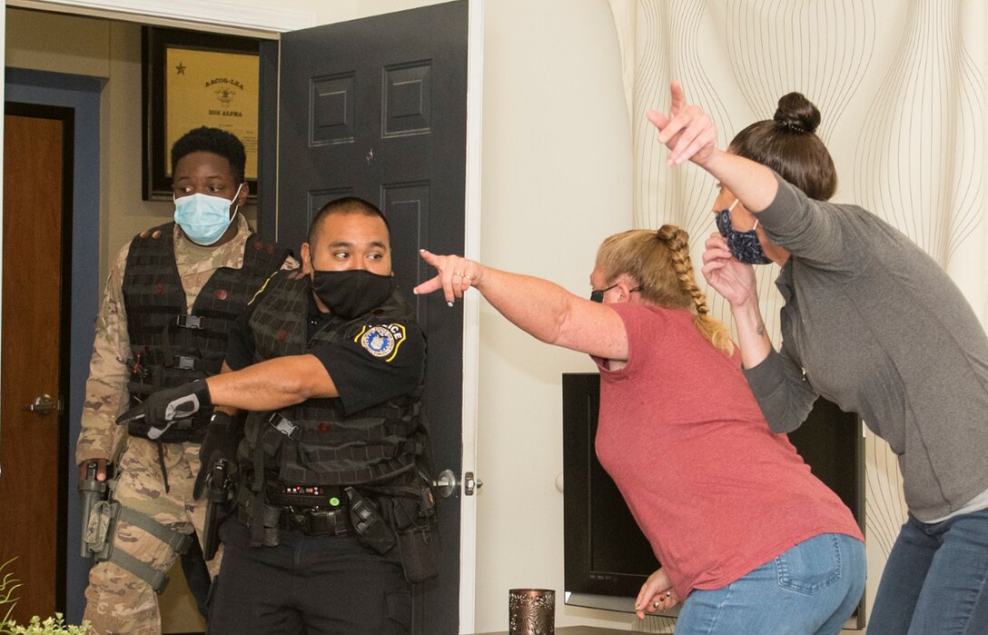 Officer Joseph Martinez, 802nd Security Forces Squadron, and Senior Airman Marcus Allen, 902nd SFS, respond during a domestic violence exercise at the Alamo Area Council of Governments, San Antonio, Texas, Oct 22, 2020. Security Forces were able to work with law enforcement training instructors from AACOG  to get a perspective outside the traditional security forces training.