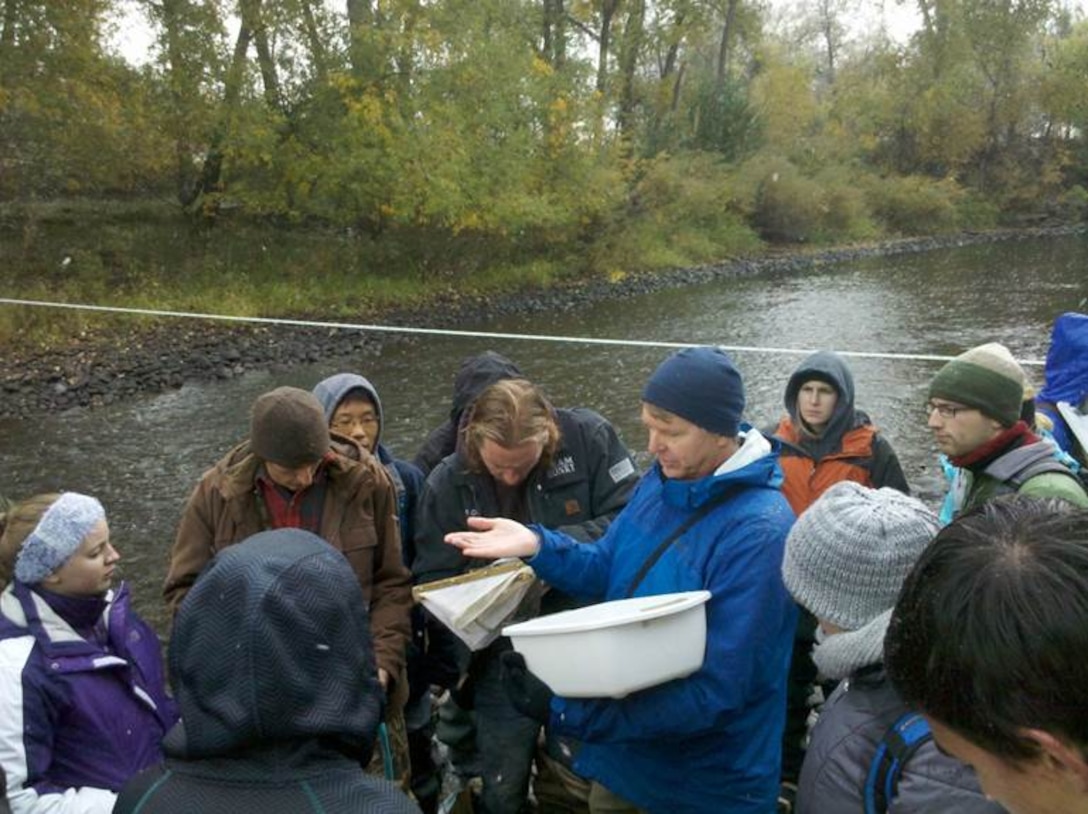 Dr. Brian Bledsoe and graduate students discussing connections between infrastructure and river ecosystems.