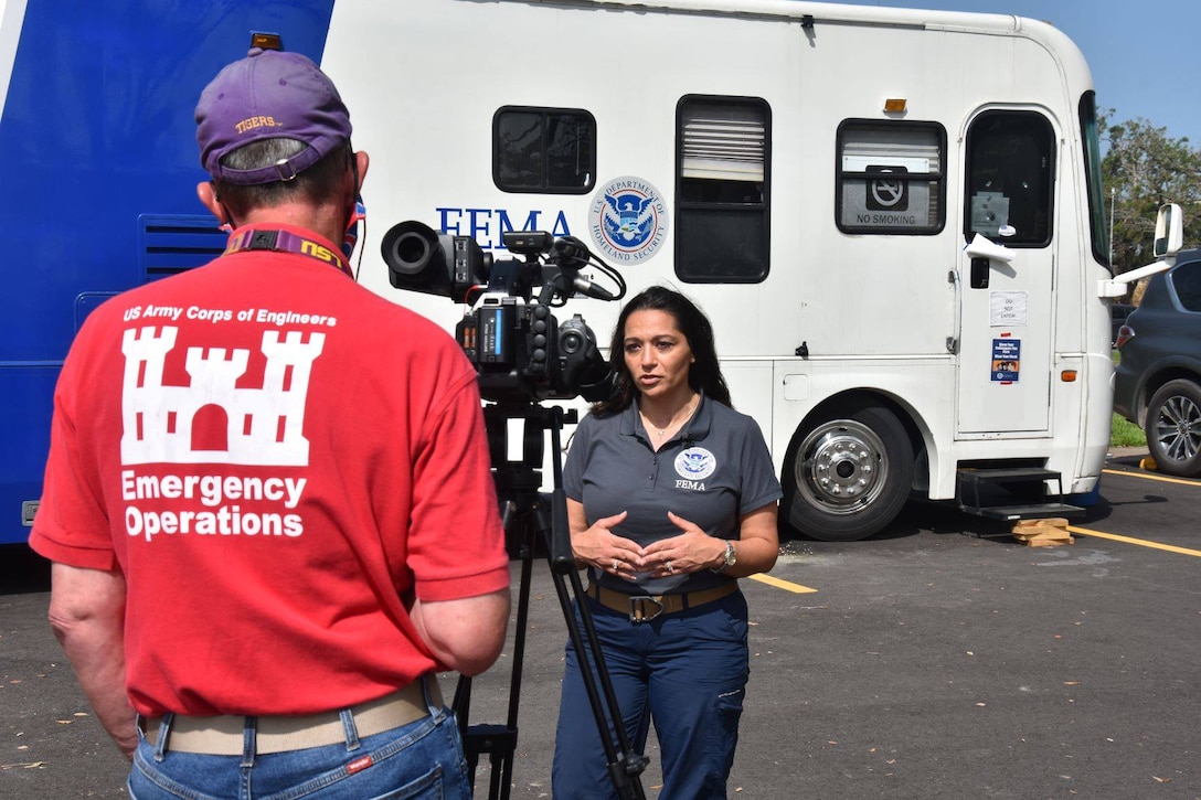 USACE broadcaster Mike Glasch, US Army Corps of Engineers, Omaha District, interviews Brandy Cross, FEMA Federal Emergency Management Agency base camp manager, for an upcoming video about the Hurricane Laura response. FEMA stood up this site as a way for personnel from outside the area to eat, work and sleep closest to where response activities are occurring. Prior to establishment to the base camp, USACE and FEMA responders were traveling 2-3 hours one way from the closest available lodging. (Photo by George Stringham)