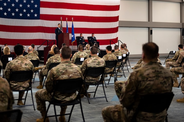 A photo of an Airman speaking during a ceremony