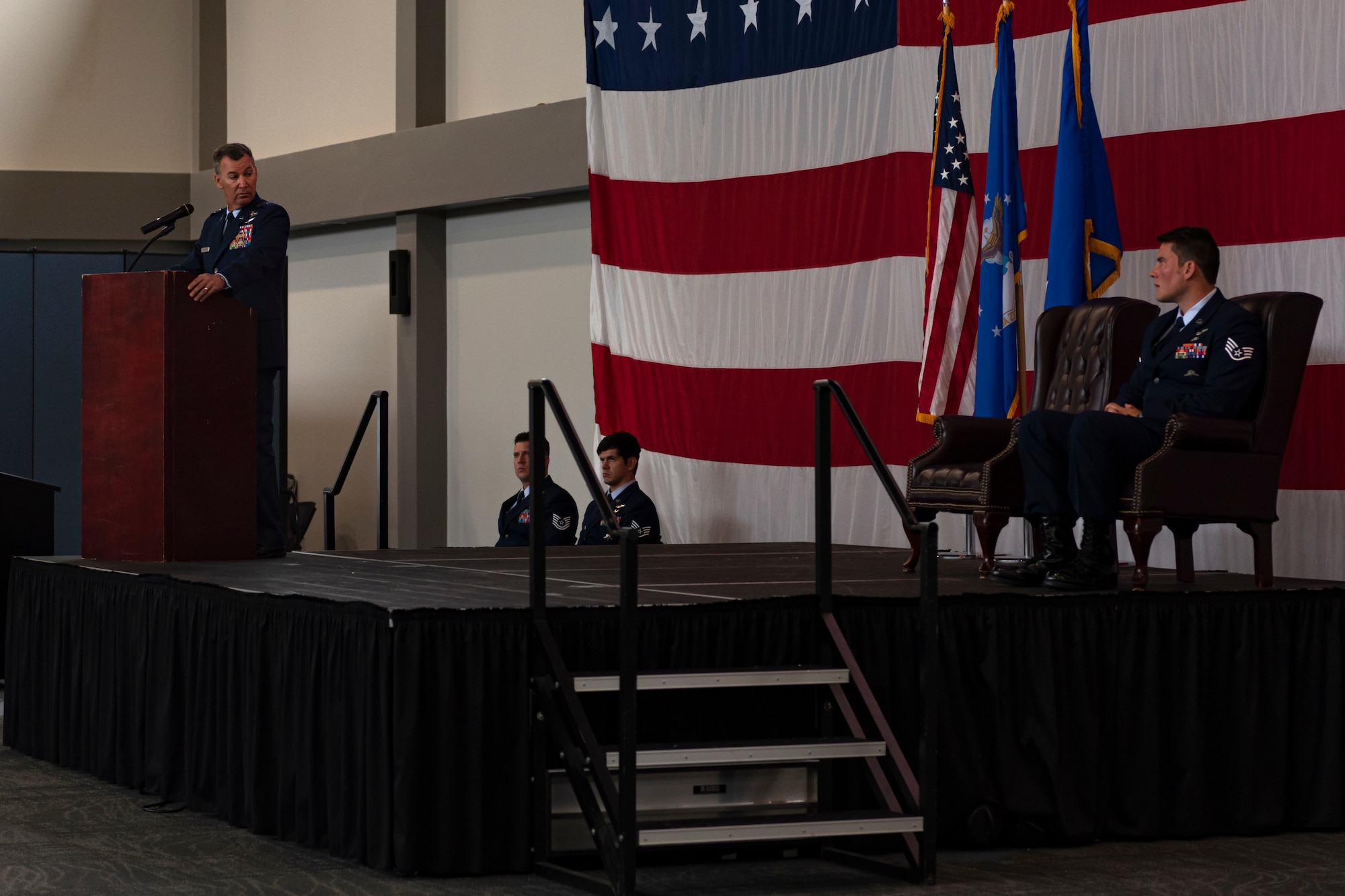 A photo of an Airman speaking during a ceremony