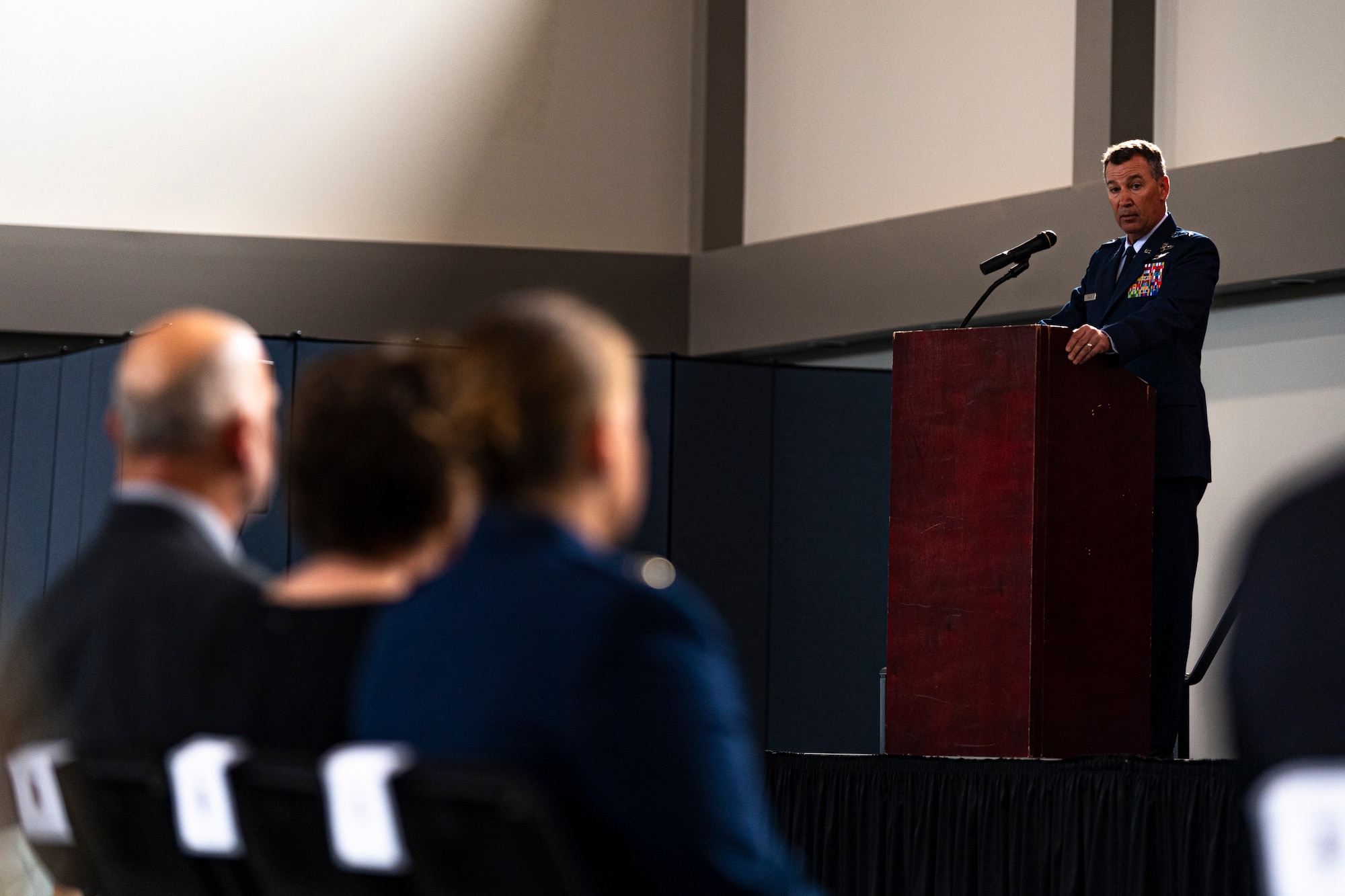 A photo of an Airman speaking during a ceremony