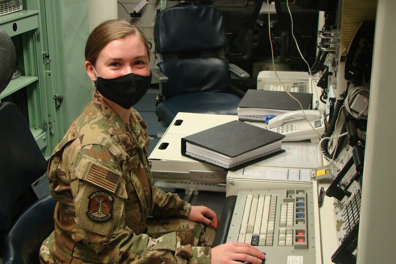 Woman poses for a photo in a launch control center.