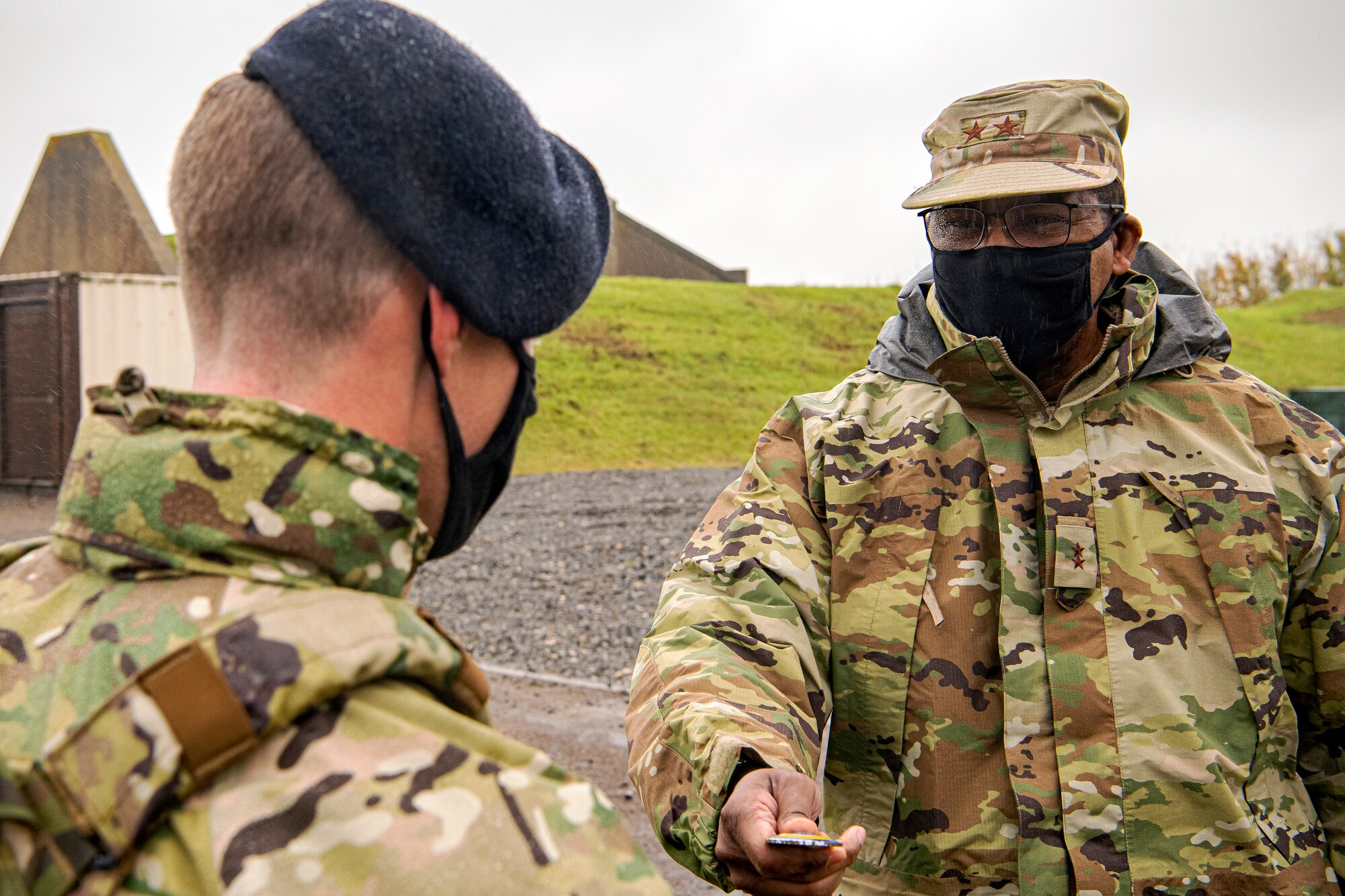 U.S. Air Force Maj. Gen. Randall Reed (right), Third Air Force commander, presents a coin to Senior Airman Eric Wilson, 422nd Security Forces Squadron installation patrolman, at Royal Air Force Croughton, England, Oct. 27, 2020. The Third Air Force command team visited multiple squadrons throughout RAF Croughton to recognize and speak with Airmen and civilians from across the base. (U.S. Air Force photo by Senior Airman Eugene Oliver)