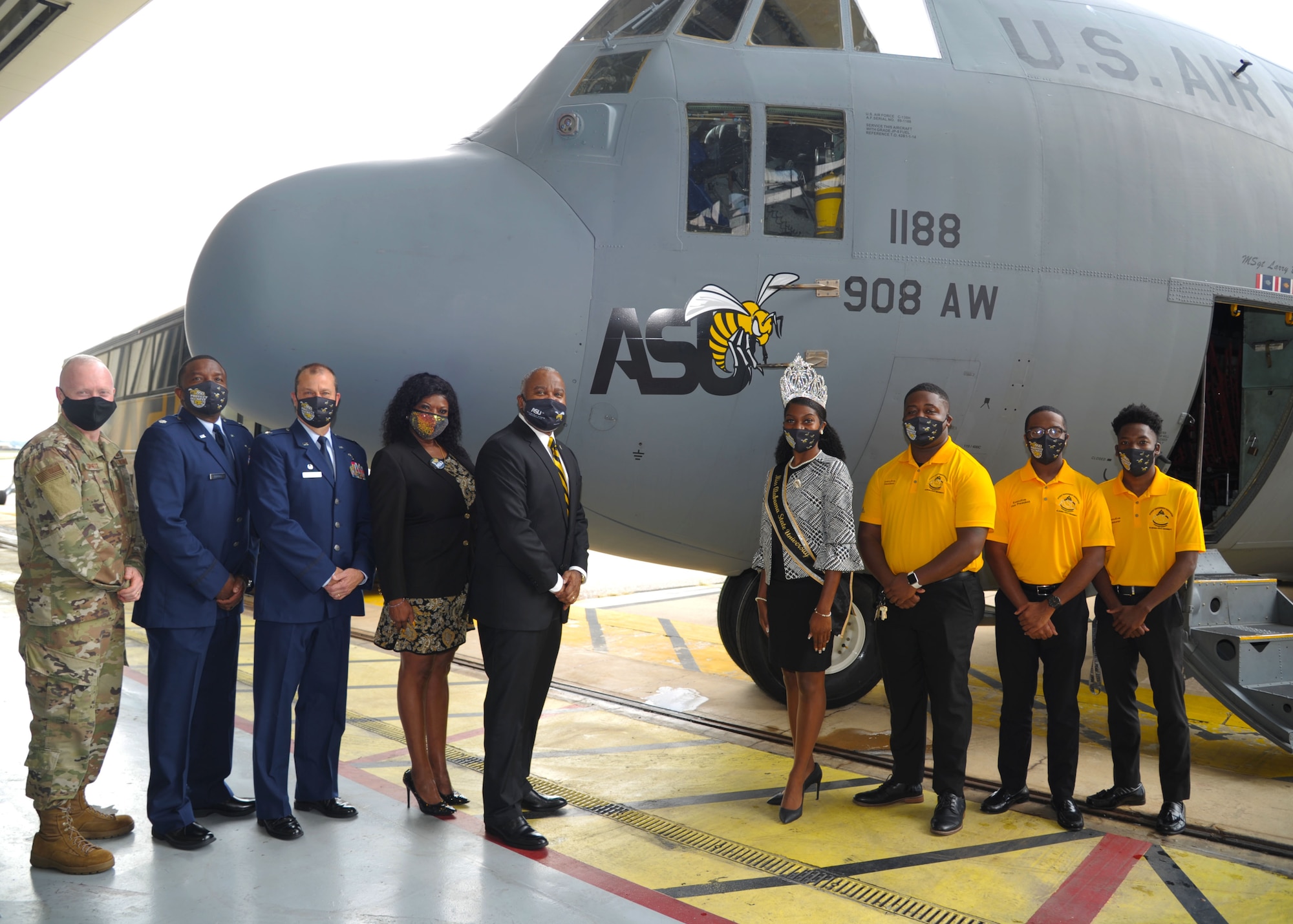 Members of the 908th Airlift Wing and representatives of Alabama State University pose for a photo in front of the newly unveiled ASU nose art at Maxwell Air Force Base, Alabama. The 908th AW commemorated its partnership with ASU by painting the university’s logo on the nose of one of its C-130 H aircraft. (U.S. Air Force photo by Senior Airman Max Goldberg)