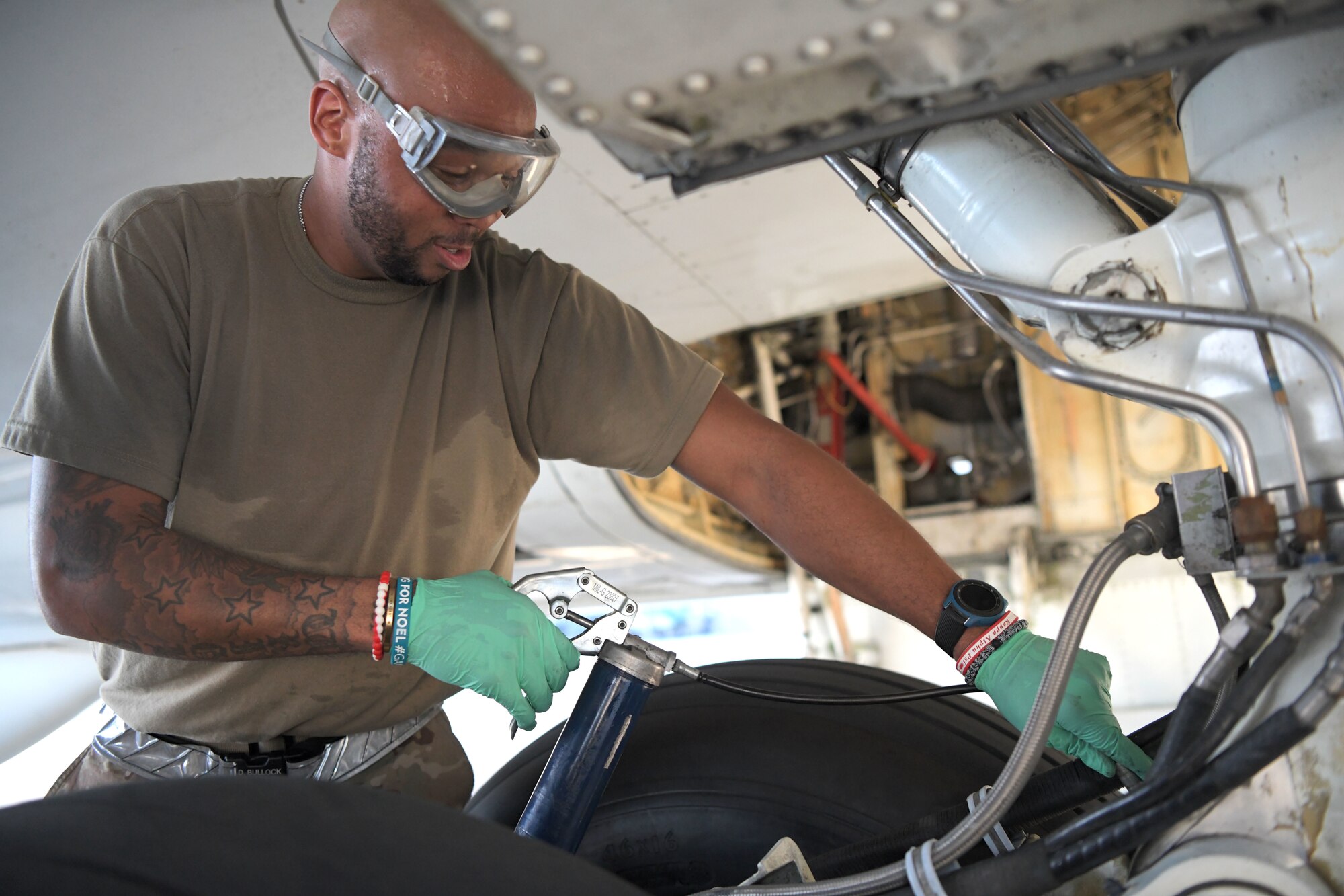 Staff Sgt. Dermayne Bullock, an E-8C joint surveillance target attack radar system crew chief with the 5th Expeditionary Airborne Command and Control Squadron, lubricates landing gear, Sept. 24, 2020, at Kadena Air Base, Japan. The Air National Guard and active duty members from Robins Air Force Base, Georgia, are on three-month rotations to work with the 5EACCS on KAB to promote total force integration and joint interoperability. (U.S. Air Force photo by Airman 1st Class Rebeckah Medeiros)