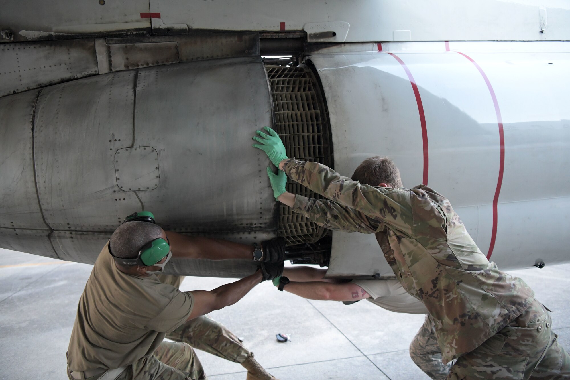 5th Expeditionary Airborne Command and Control Squadron Joint Surveillance Target Attack Radar System team members work together to remove outer engine components of an E-8C Joint STARS aircraft at Kadena Air Base, Japan, Sept. 24, 2020. The Air National Guard and active duty members from Robins Air Force Base, Georgia, are on three-month rotations to work with the 5th EACCS on KAB to promote total force integration and joint interoperability. (U.S. Air Force photo by Airman 1st Class Rebeckah Medeiros)